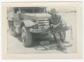 Photograph: [William Giannopoulos Leaning on a Half-Track]