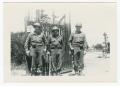 Photograph: [Three Soldiers Standing by a Gate]