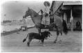 Photograph: Woman on Her Horse with a Dog