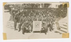 Primary view of object titled '[Company B of the 134th Ordnance Maintenance Battalion Posing by a Sign]'.