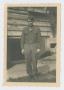 Photograph: [Soldier In Front of House]
