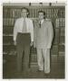 Photograph: [Two Men in Front of a Bookcase]
