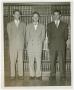 Photograph: [Three Men in Front of a Bookcase]