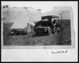 Photograph: Woman and Children by Truck with Trailer and Tent