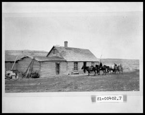 Primary view of object titled 'Men on Horses in Front of House'.