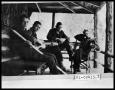 Thumbnail image of item number 1 in: 'Four Men Sitting on Porch with Guitar'.