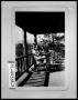 Photograph: Two Women in Rocking Chairs on Cabin Porch
