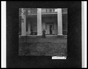 Primary view of object titled 'Lady in Front of Large House'.