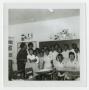 Photograph: [Students and their Teacher in a Classroom]