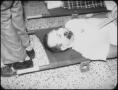 Photograph: [Close-Up of Man on Stretcher]