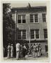 Primary view of [Men Reeling Hose Up Side of Building]