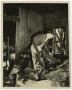 Photograph: [Firefighter Inside Charred Building]