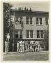 Primary view of [Men Taking Hose Up Side of Building]