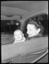 Photograph: [Woman in Car Holding Child]