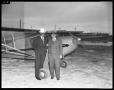 Photograph: [Two Men Standing with Plane]