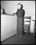 Photograph: [Young Man Standing at Counter]