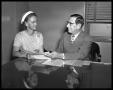 Photograph: Man and Woman Seated at Desk