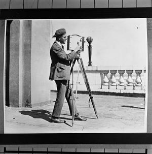 Primary view of object titled '[Cameraman Preparing Camera]'.