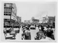 Photograph: [Crowd in a Street behind a Motorcade]
