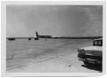 Primary view of [Airplane on a Runway with Several Nearby Vehicles]