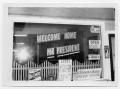 Photograph: [Storefront with Signage Welcoming the President]