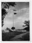 Photograph: [U. S. and Presidential Flags Flying Over a Ranch]