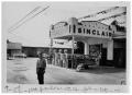 Photograph: [Man Stands Outside a Gas Station]