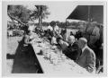 Primary view of [People Sitting at a Picnic Table]