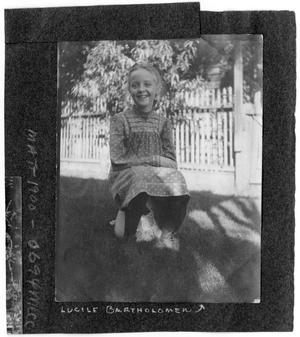 Primary view of object titled '[Lucile Bartholomew Sitting and Smiling Outdoors]'.