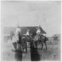 Photograph: [Three Riders in front of a House]