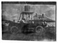 Photograph: [People in a Car near a Water Tower]