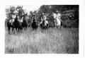 Photograph: [Five People on Horseback in a Field]