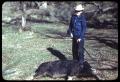 Photograph: [Tom Blanton with Shotgun Standing over a Dead Hog]
