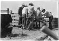 Photograph: [Cowboys Around a Cattle Branding Station]