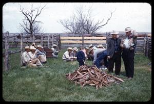 Primary view of object titled '[Cowboys Having a Meal in a Fenced Area]'.