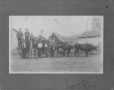 Photograph: [Twelve Men Standing in Front of and on Top of a Wagon]