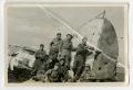 Photograph: [A Group of Soldiers Standing on an Airplane]