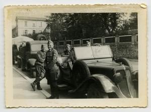 Primary view of object titled '[German Soldiers Standing Around a Car]'.