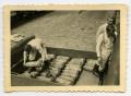 Photograph: [Three Soldiers Loading 105 mm. Shells]