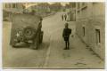 Primary view of [Photograph of a Boy Next to a Jeep]