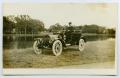 Postcard: [Postcard with a Photo of a Fire Chief in his Car]