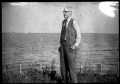 Photograph: [A.P. George standing in a field]