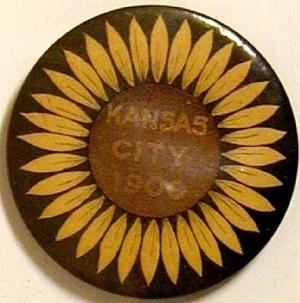 Primary view of object titled '[Button with a sunflower painted on the it and states: "KANSAS CITY 1900"]'.