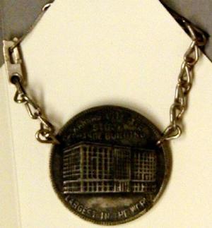 Primary view of object titled '[Medallion, hangs on chain reads: "KANSAS CITY LIVE STOCK EXCHANGE BUILDING LARGEST IN THE WORLD" on front]'.
