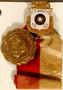 Thumbnail image of item number 1 in: '[Gold medal with red and white ribbon]'.
