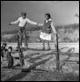 Thumbnail image of item number 1 in: '[Bailey Woods and Sue Antoinette Emory Standing on Fence]'.