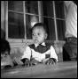 Photograph: [Young Boy Sitting at a Table]