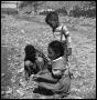 Photograph: [Three Children on a Rocky Bank]