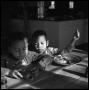 Photograph: [Two of Oliver Jacobs' Grandchildren at a Table]