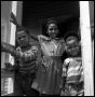 Photograph: [Three Children at a Porch Doorway]